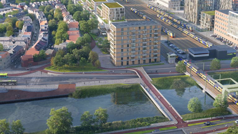 Luchtfoto van een stedelijke omgeving met moderne gebouwen, treinsporen, fietspaden, water en groen.